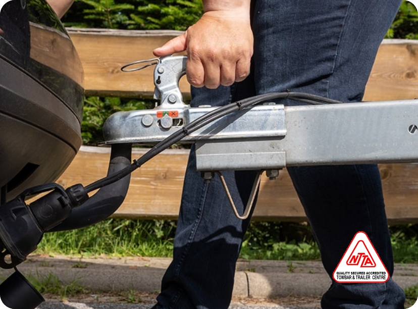 man attaching towbar